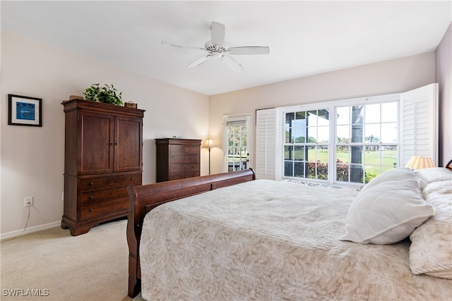 carpeted bedroom featuring ceiling fan and multiple windows