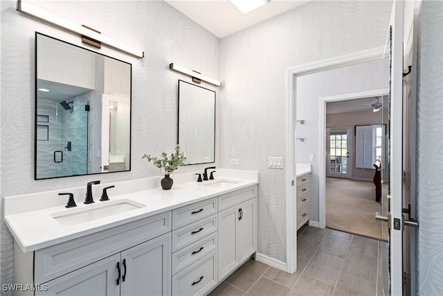 bathroom featuring tile patterned floors, vanity, and a shower with door