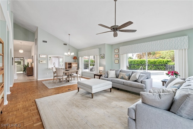 living room with ceiling fan with notable chandelier, parquet flooring, and high vaulted ceiling