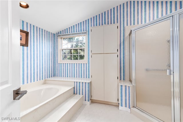 bathroom featuring tile patterned flooring, lofted ceiling, and plus walk in shower