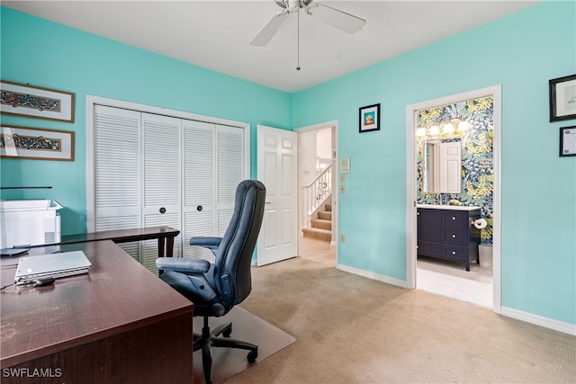 office space with ceiling fan and light carpet