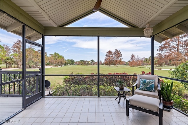 unfurnished sunroom featuring lofted ceiling with beams