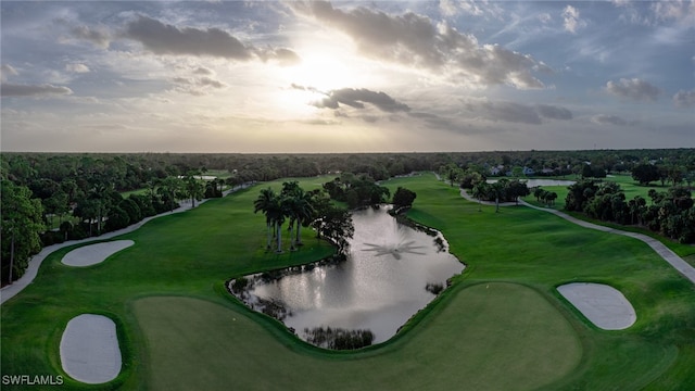 aerial view at dusk featuring a water view