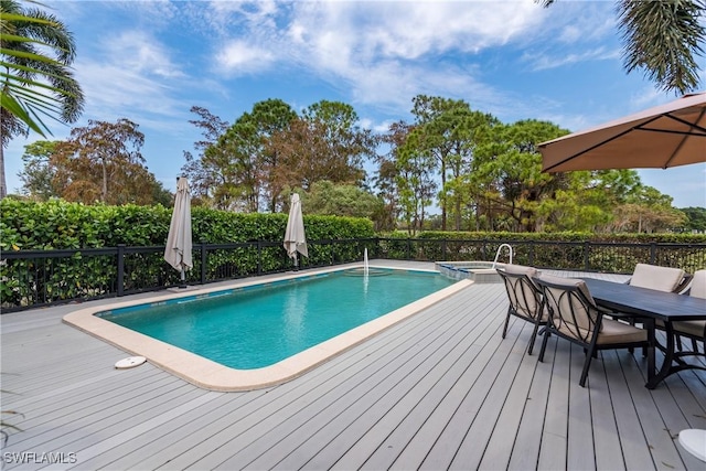 view of swimming pool featuring an in ground hot tub