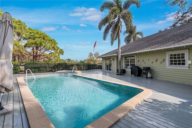 view of pool with an in ground hot tub and a deck