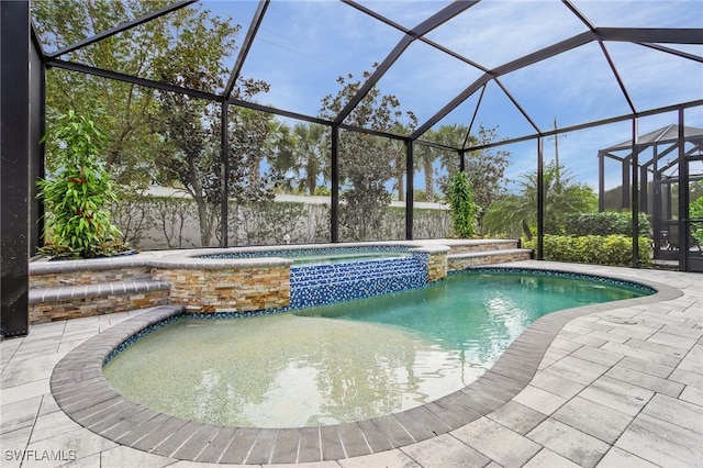 view of swimming pool featuring an in ground hot tub, a lanai, and a patio