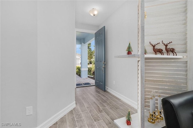 entrance foyer featuring wood tiled floor and baseboards