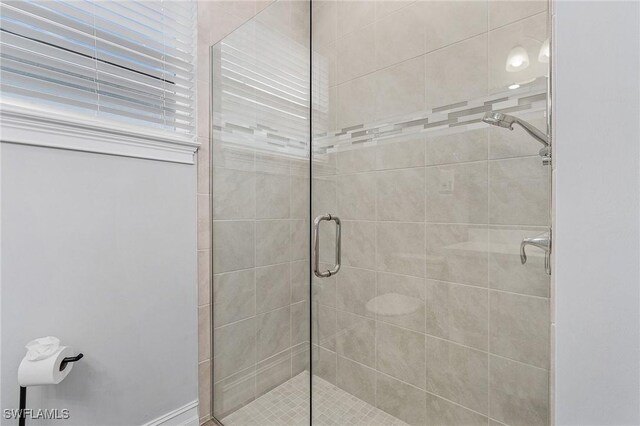 bathroom with a shower with shower door