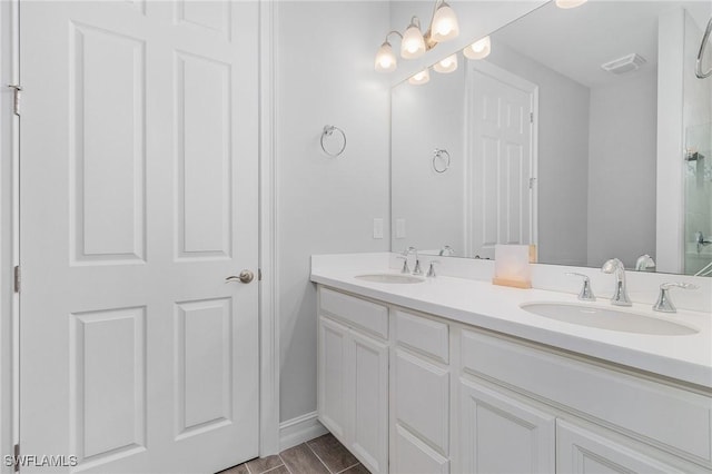 bathroom featuring an inviting chandelier and vanity