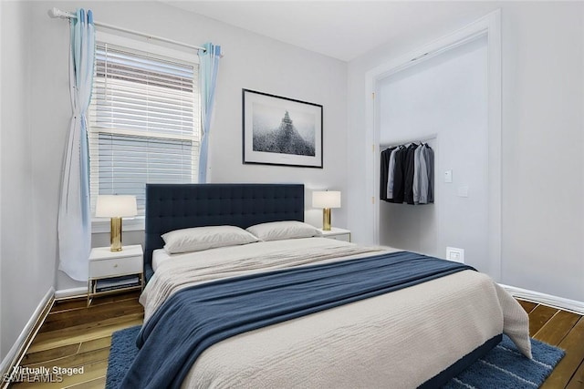 bedroom featuring baseboards and wood finished floors