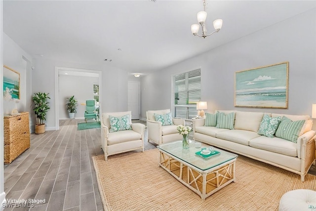 living room with an inviting chandelier and hardwood / wood-style floors