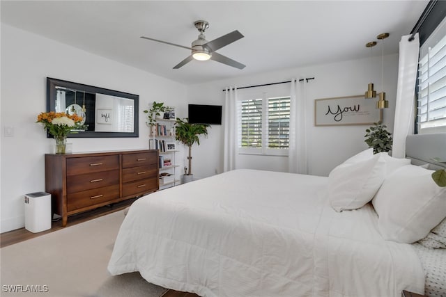 bedroom featuring wood-type flooring and ceiling fan