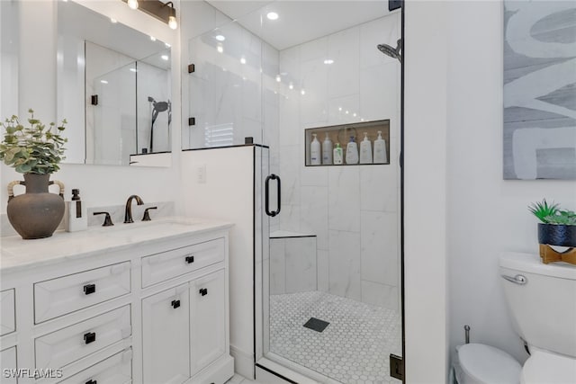 bathroom with a shower with door, toilet, and vanity