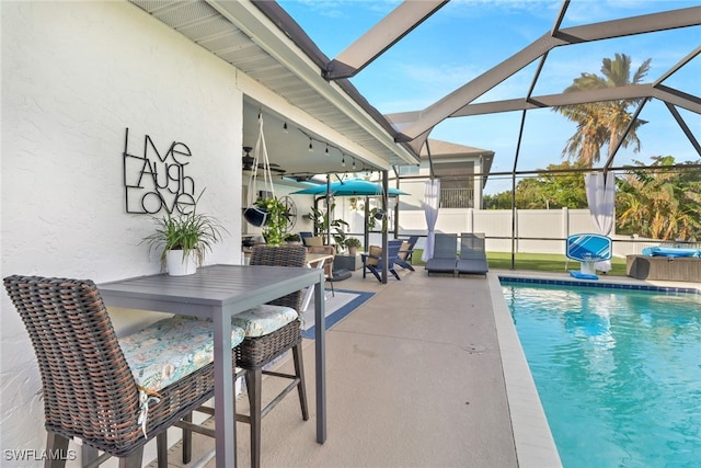 view of pool with a patio area and a lanai