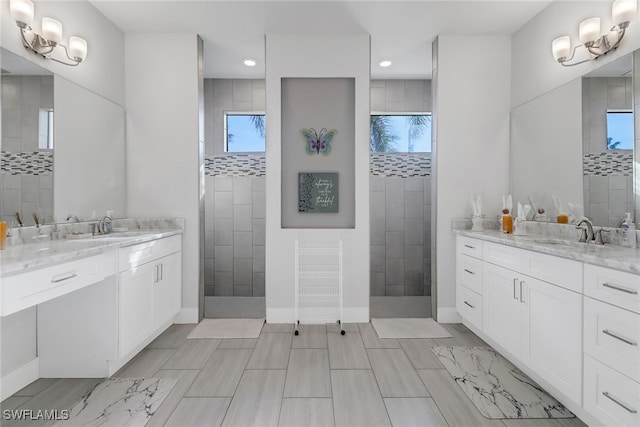 bathroom with a tile shower and plenty of natural light