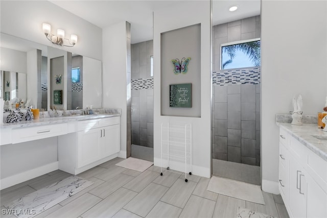 bathroom featuring vanity and tiled shower