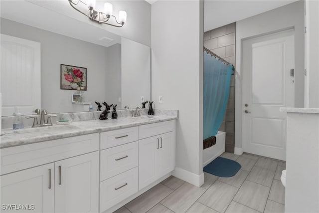 bathroom featuring vanity, an inviting chandelier, and shower / tub combo with curtain