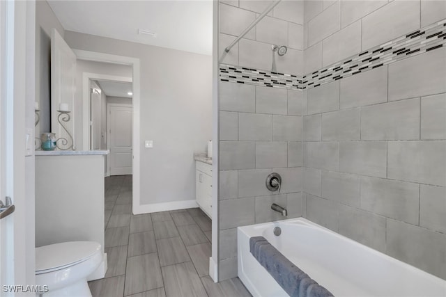 full bathroom featuring toilet, vanity, and tiled shower / bath combo