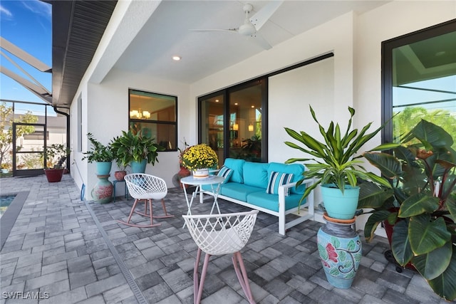 view of patio / terrace with an outdoor living space, ceiling fan, and a lanai