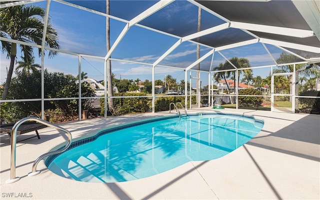 view of pool with a patio area and a lanai