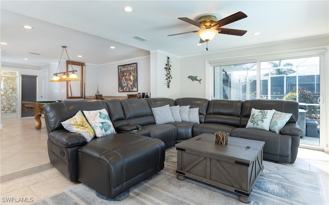 living room featuring crown molding, light tile patterned flooring, and ceiling fan