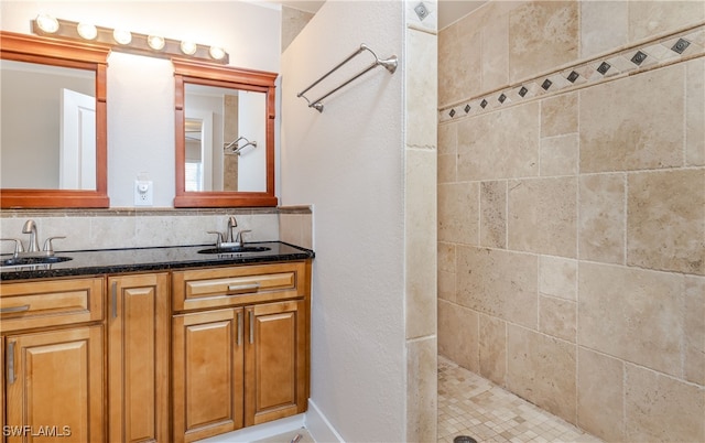 bathroom with vanity and tiled shower