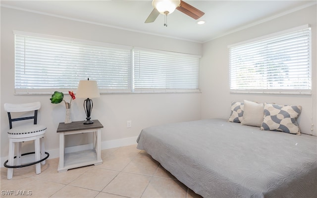 tiled bedroom with ceiling fan and ornamental molding