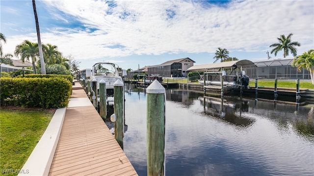 dock area featuring a water view and glass enclosure