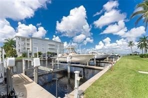 view of dock with a water view and a lawn