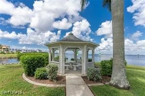 view of home's community with a gazebo, a yard, and a water view