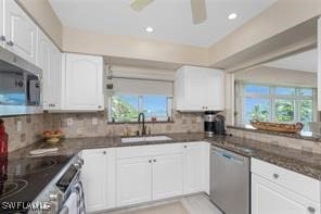 kitchen with white cabinetry, appliances with stainless steel finishes, sink, and plenty of natural light