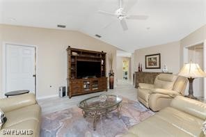 living room featuring ceiling fan and vaulted ceiling