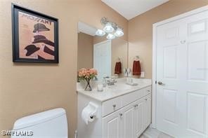 bathroom featuring toilet and vanity