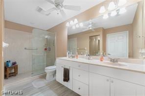 1250 W Marion Ave Unit 242, Punta Gorda, FL 33950 - full bathroom with toilet, double vanity, a shower with shower door, and ceiling fan