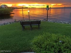 exterior space with a water view and a lawn