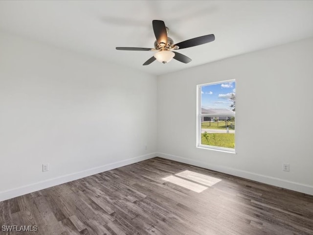 spare room featuring ceiling fan and dark hardwood / wood-style flooring