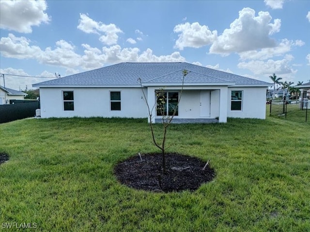 back of property featuring a yard