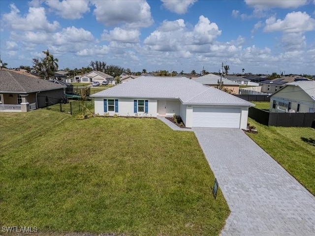 ranch-style house featuring a front lawn and a garage