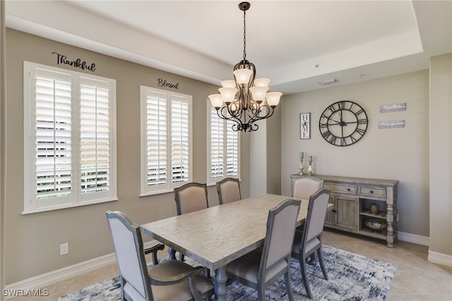 dining room with a chandelier and light tile patterned floors