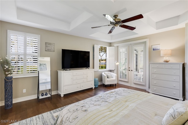 bedroom featuring dark wood-type flooring, a raised ceiling, access to exterior, and ceiling fan