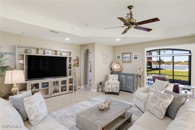 living room featuring arched walkways, ceiling fan, recessed lighting, visible vents, and baseboards