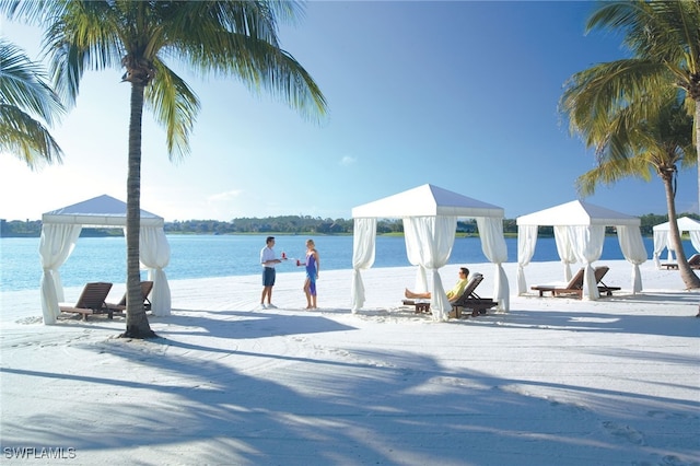 view of property's community with a water view and a gazebo