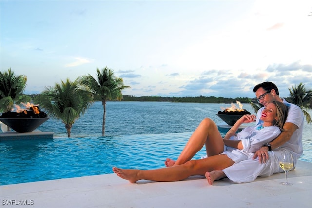 view of pool featuring a water view