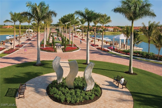 view of play area featuring a lawn and a water view