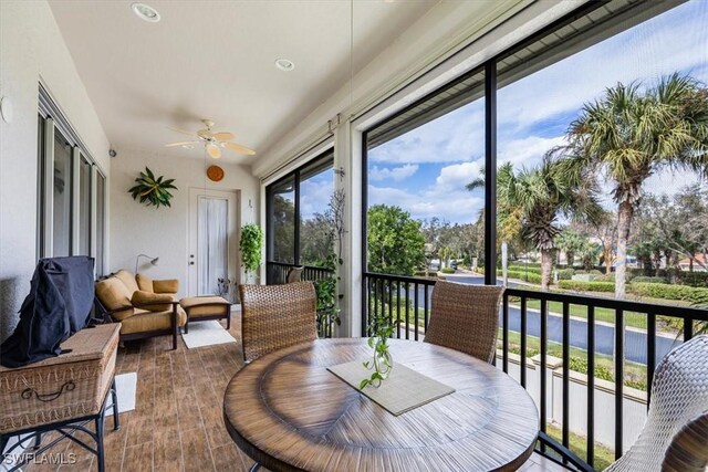 sunroom featuring ceiling fan