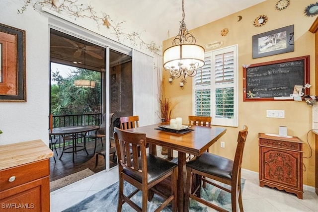 tiled dining room with an inviting chandelier