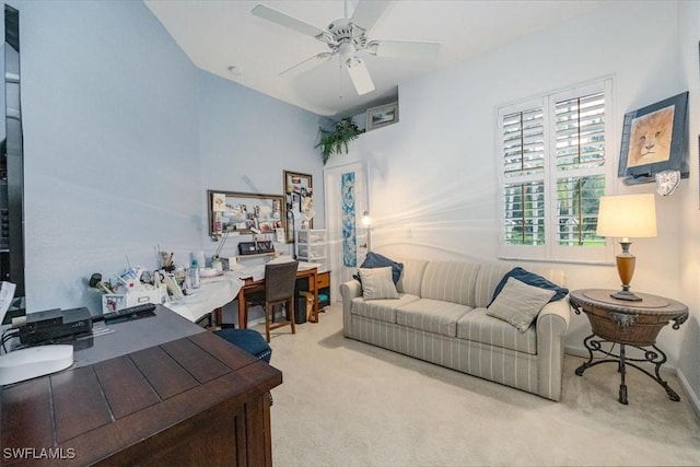 carpeted office space featuring ceiling fan