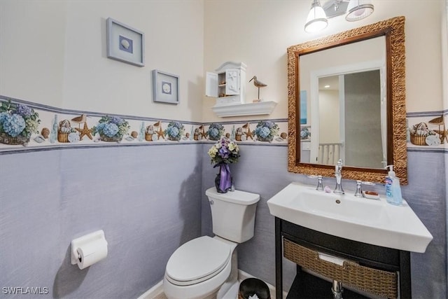 bathroom featuring toilet and vanity