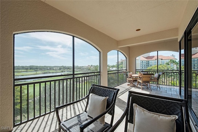 2546 Marquesa Royale Ln Unit 7-302, Naples, FL 34109 - sunroom / solarium with a water view and an outdoor living space