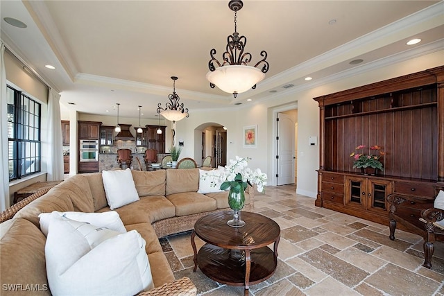 2546 Marquesa Royale Ln Unit 7-302, Naples, FL 34109 - living area featuring arched walkways, stone tile flooring, a tray ceiling, crown molding, and recessed lighting